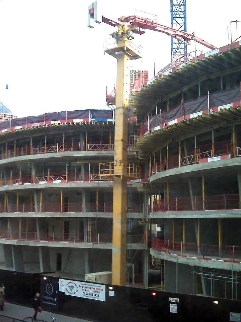 Active construction site with concrete pump in operation
